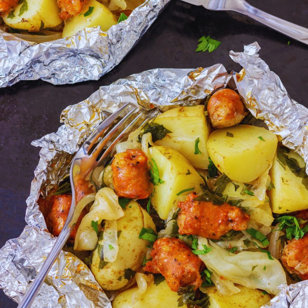 potatoes and sausage in a foil packet with herbs and onions