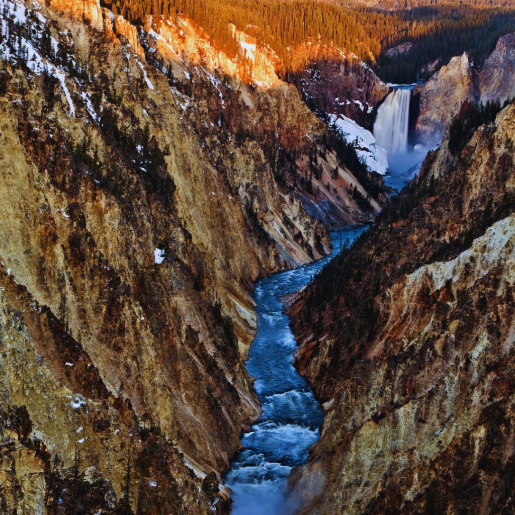 yellowstone national park with a waterfall and a river running through a canyon