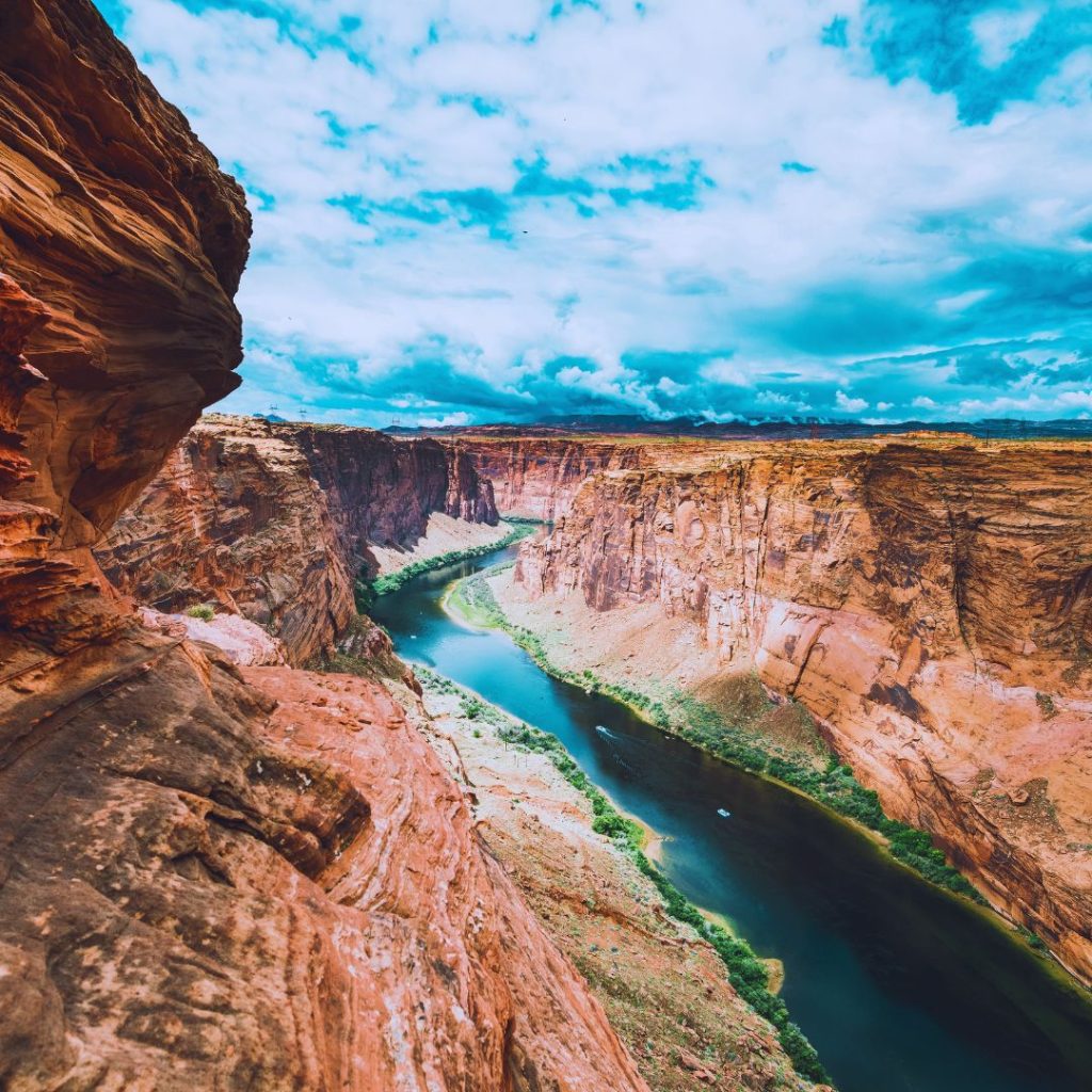 The river running through the grand canyon with red cliffs on either side