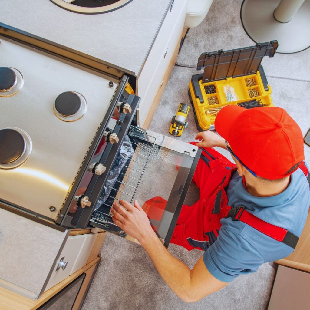 maintenance worker repairing the stove