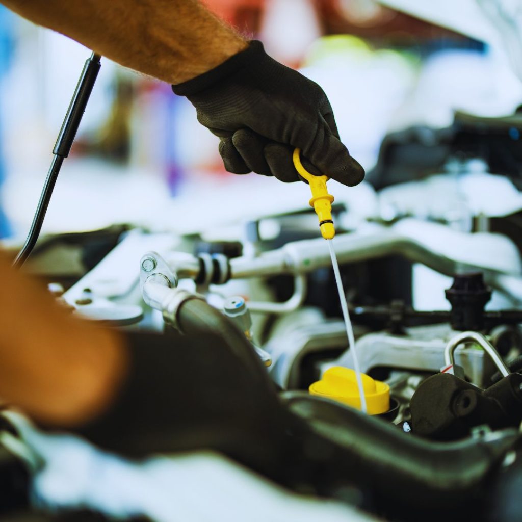 mechanic checking the oil